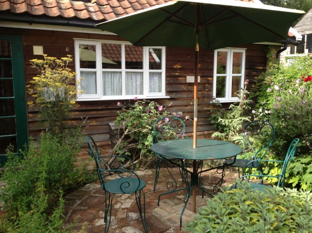aw. there's my kitchen window looking out onto the herb garden. guests are welcome to pick whichever herbs they like to use in the kitchen. it almost makes me wish i liked to cook