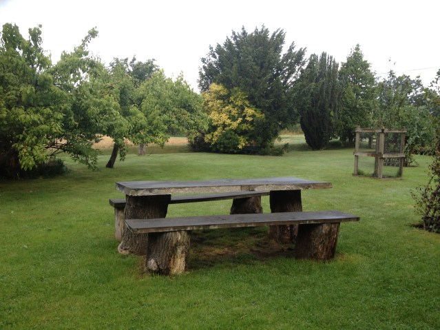 this picnic table set is basically wooden slabs placed on tree stumps. i actually managed to sit on the bench and write in my diary without incident