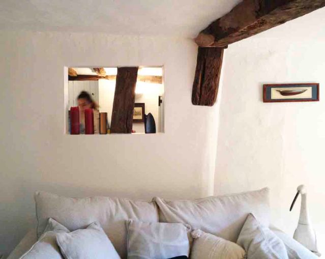 peekaboo window looks onto the dining room/foyer and kitchen. i'm 5'7" and can easily put my hands flat against the ceiling. but funny enough, i didn't feel claustrophobic at all