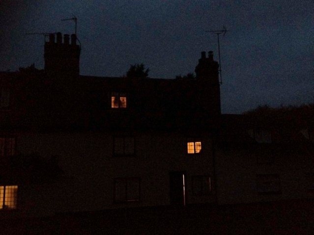 next day morning. i wanted an eerie shot of zainab looking out our bedroom window on top. the window to the right is yousef's. the one to the left is our neighbors'