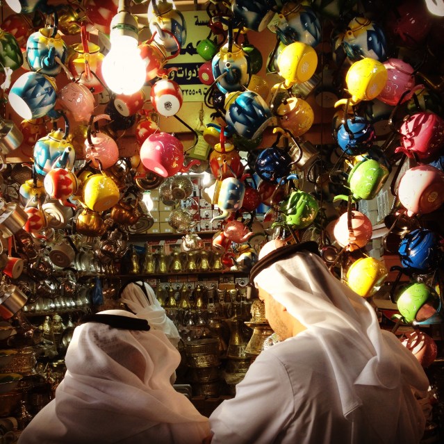 two men ponder buying a tea pot at the old souq