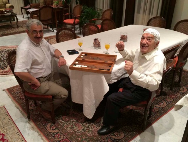 musa and sido play backgammon, sido does a sitting dance
