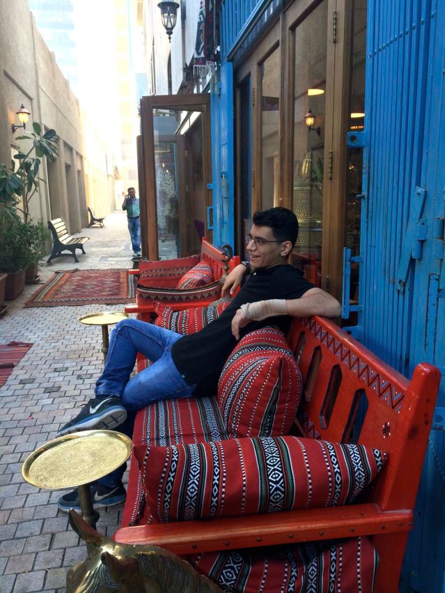 while yousef sits on a more practical bench with traditional sadu cushions