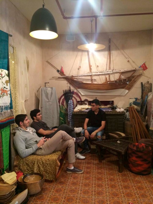 and back to the riff raff. omar, khaled and yousef chat among a dhow, chest and some ersatz swords