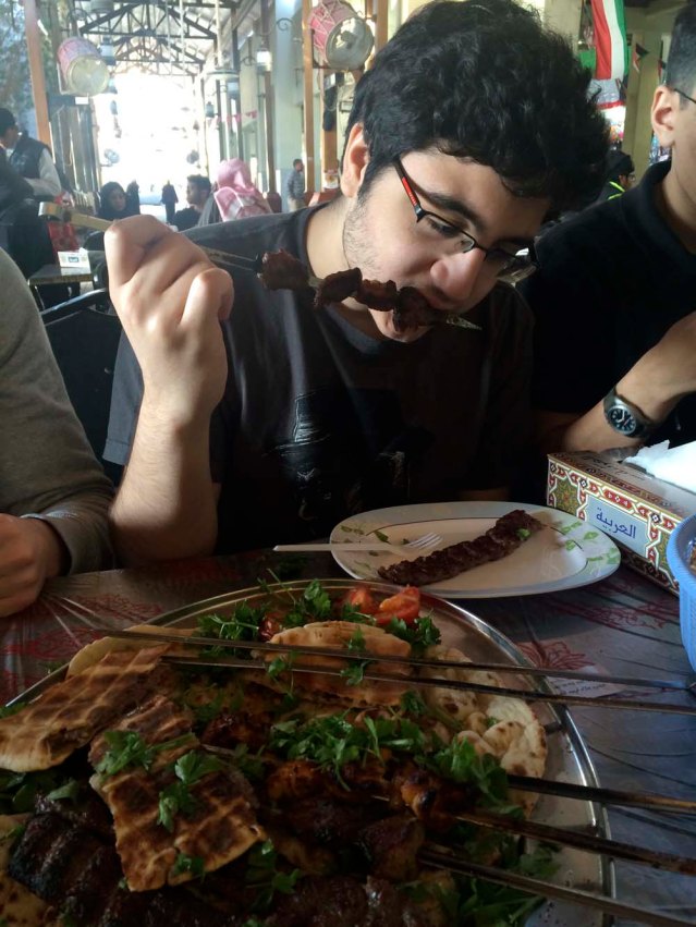 khaled devours a skewer of cow meat