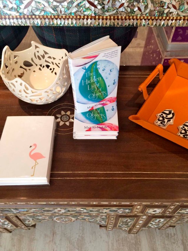 my dear friend mai al-nakib's book 'the hidden light of objects'. also an intricate ceramic piece and 'hands of fatima' by jordanian sculptor katia al-tal. and i love choux a la creme's quirky cards and notebooks, like the flamingo one here