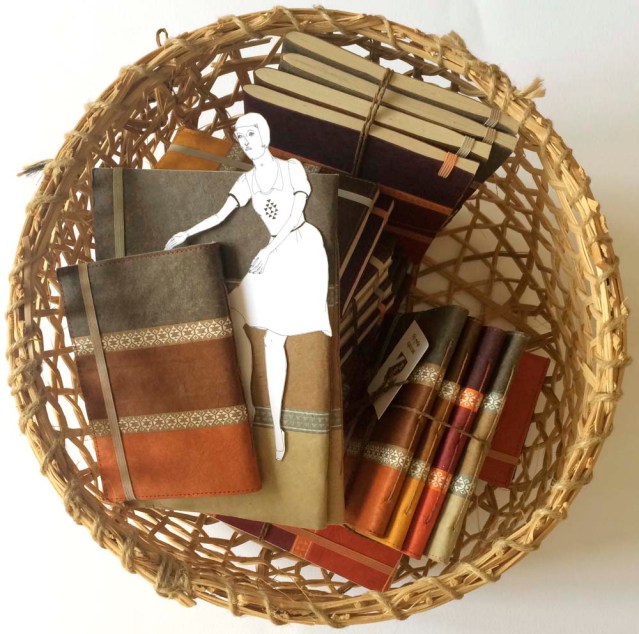 swimming in a basket of earth-toned notebooks is her favorite thing to do