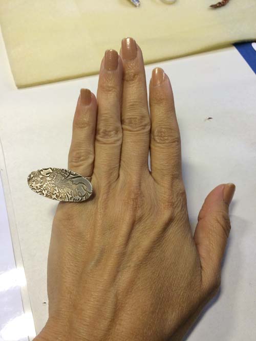 trying this really cool ring on. please ignore my witch hands and dastardly nail polish