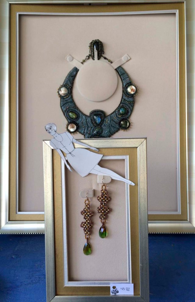 eve (head mangled by nitfa the cat) flies through lubna's beaded jewelry