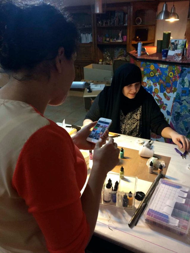 lina works on her pomegranate pendants