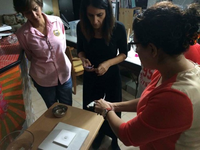 manal and i are really concentrating while hawra teaches us how to use the torch