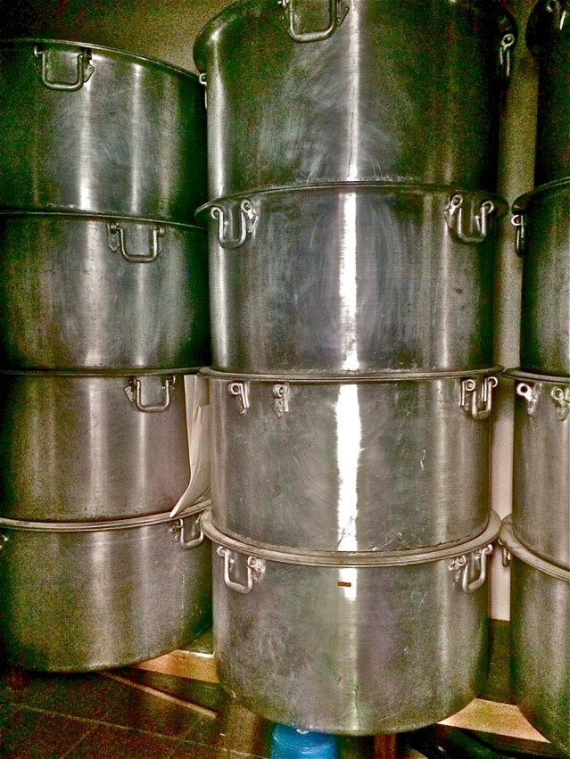 inside a storeroom are these massive pots. i see folks serving machboos and other rice dishes from these pots at ashoura and other festivals. these things are huge. humungous. i cannot express big