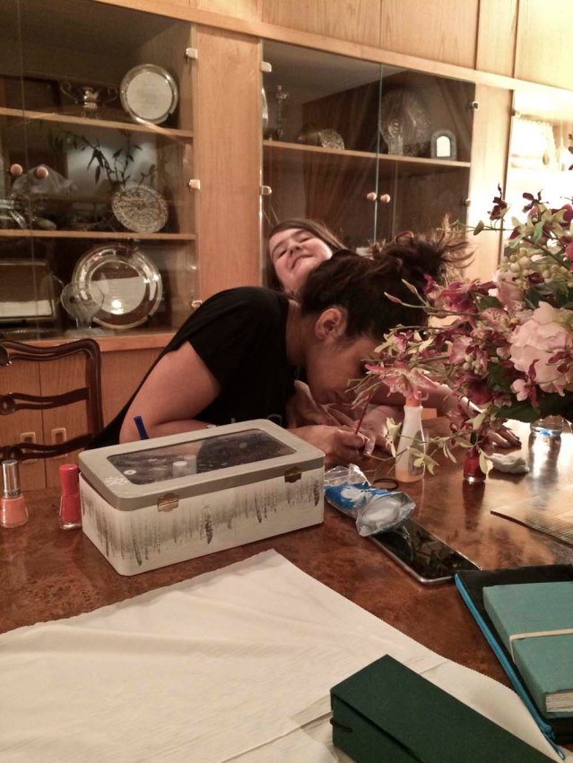 back at my parents, yasmine gives christina a manicure