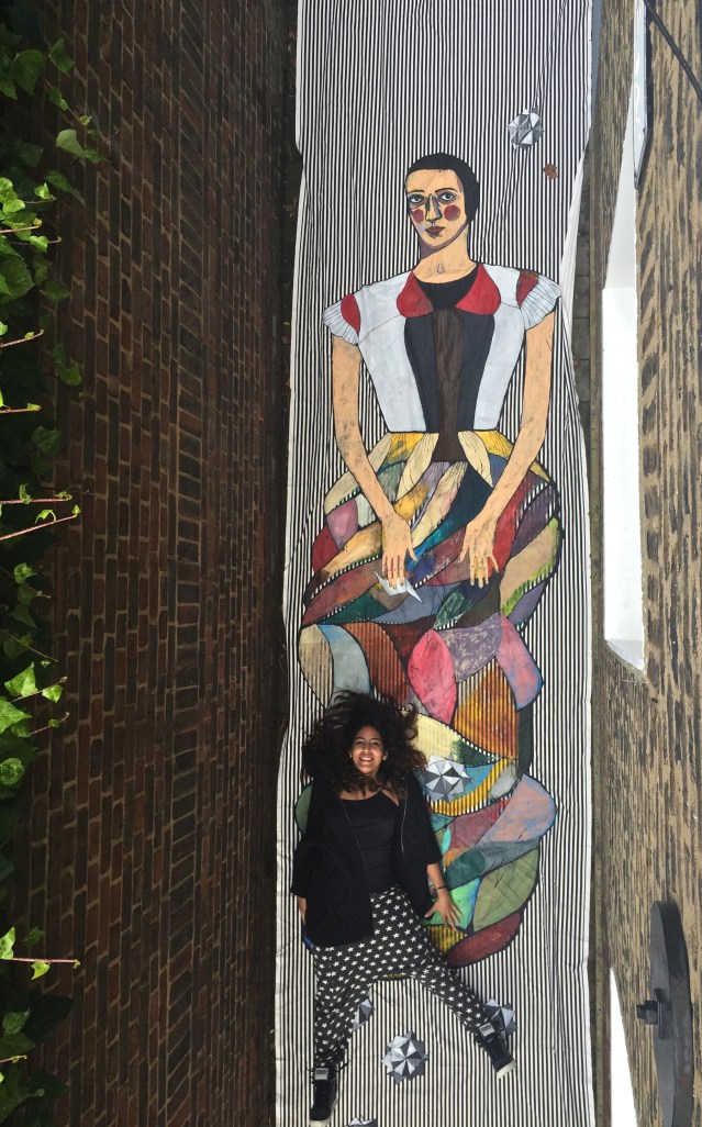 september 14 } we've been rising nice and early. this morning i ask yasmine to pose with the tap. anna's window has proved quite handy. it doesn't hurt that this quaint alleyway is just outside, never mind the colorful walker-throughs at night...