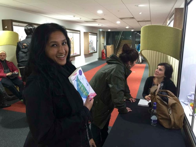 ayesha waits for her book to be signed as amira behbehani chats with mai